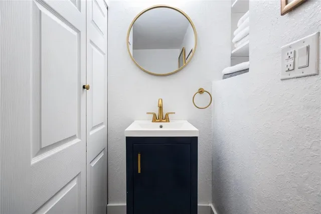 a spacious bathroom with a double vanity sink and a mirror