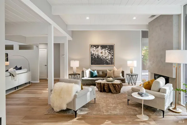 a large kitchen with kitchen island a large counter top space a sink appliances and living room view