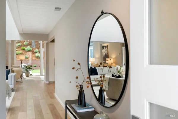 a living room with furniture and wall paintings