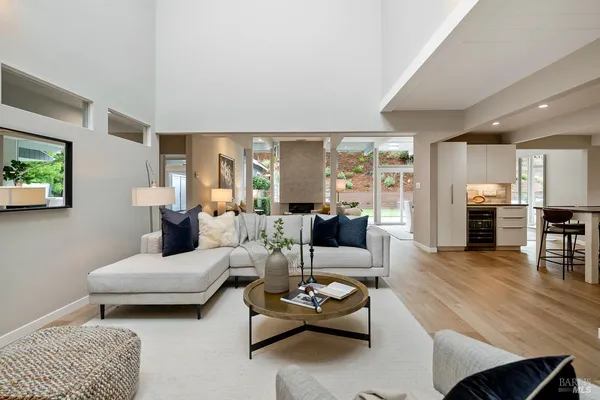 a living room with furniture fireplace and a large window