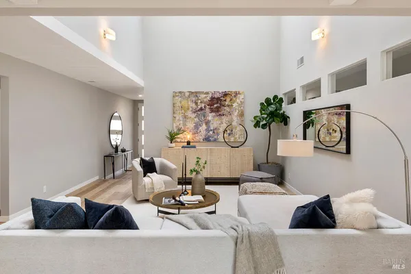 a living room with furniture fireplace and a large window