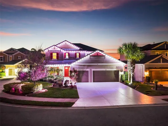 a front view of a house with a garden and parking