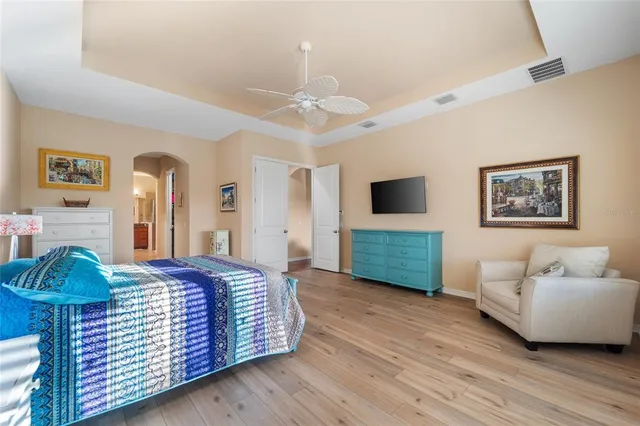 a bathroom with a granite countertop tub double vanity sink and a large mirror