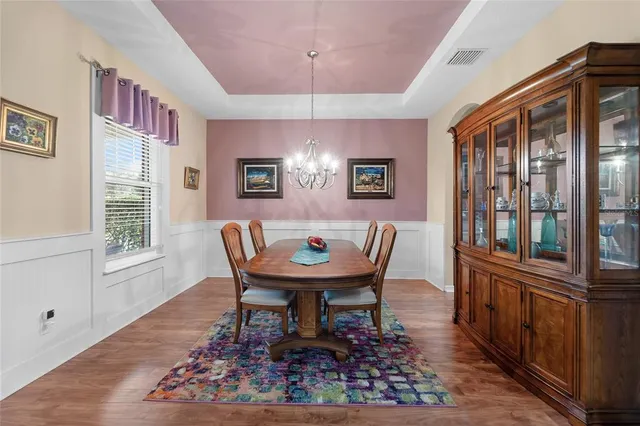 a dining room with furniture and wooden floor