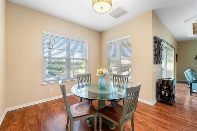 a living room with furniture flat screen tv and a large window