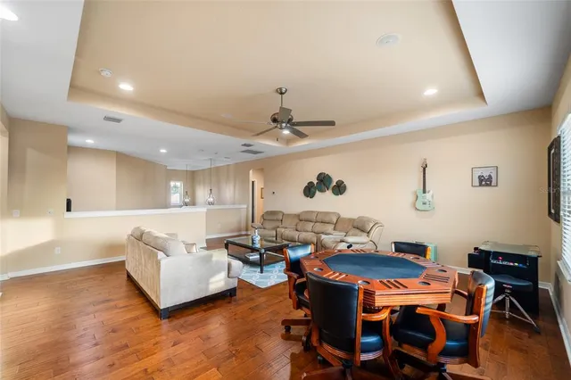 a living room with furniture a couch and a bookshelf