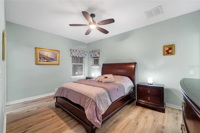 a bathroom with a granite countertop sink a mirror and shower