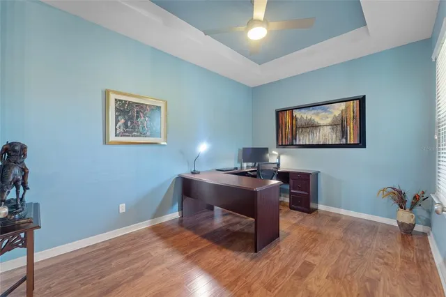 a view of a workspace with furniture and wooden floor