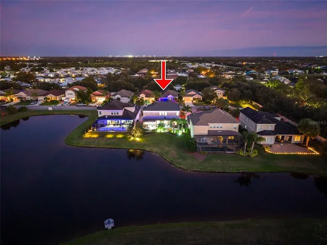 an aerial view of residential houses with outdoor space and swimming pool