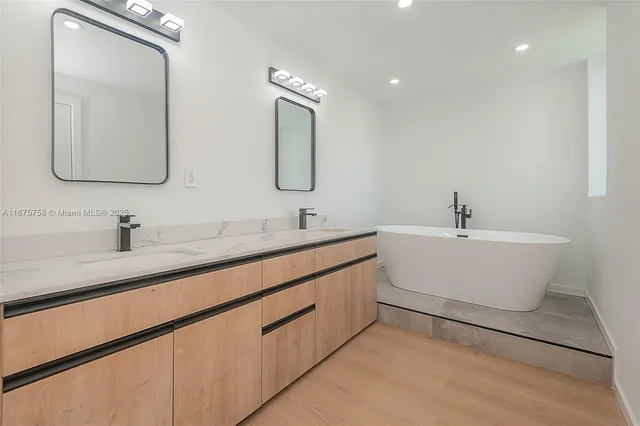a bathroom with a double vanity sink and a mirror