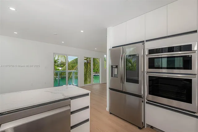 a kitchen with stainless steel appliances a stove and microwave
