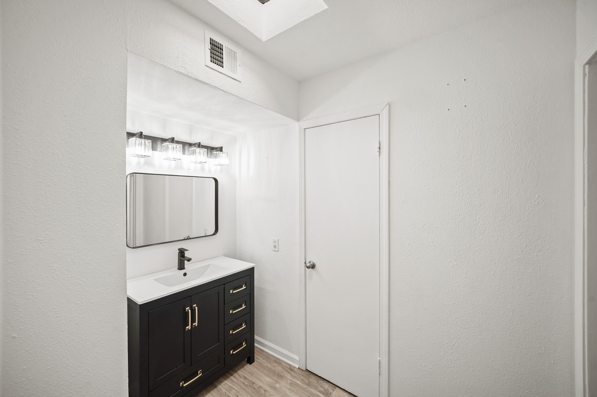 7047 Bissonnet Street, Unit 62 Houston, TX 77074 - Photo 11 of 15 a bathroom with a sink vanity and mirror