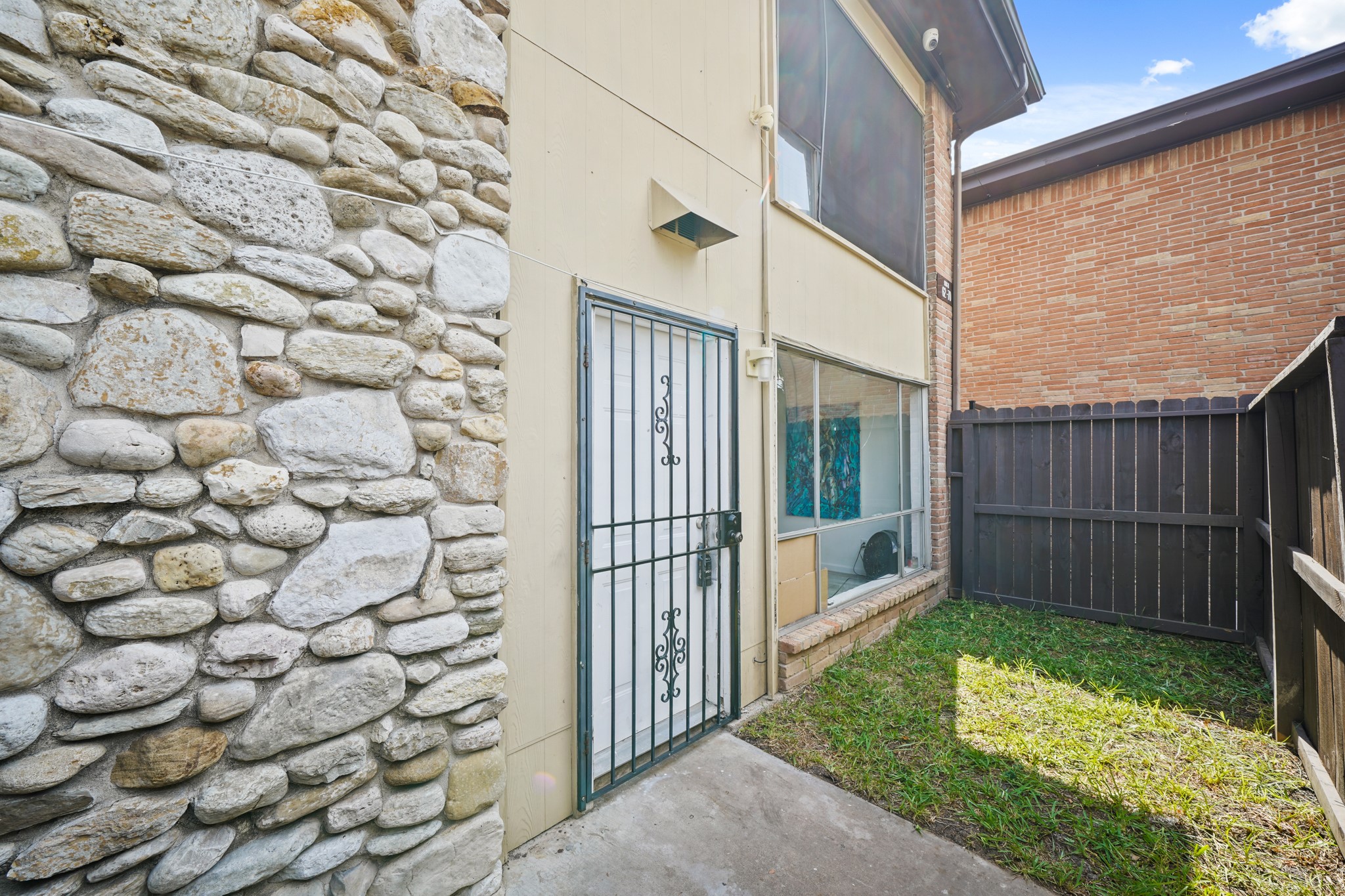 7047 Bissonnet Street, Unit 62 Houston, TX 77074 - Photo 13 of 15 a view of an entrance to house with yard