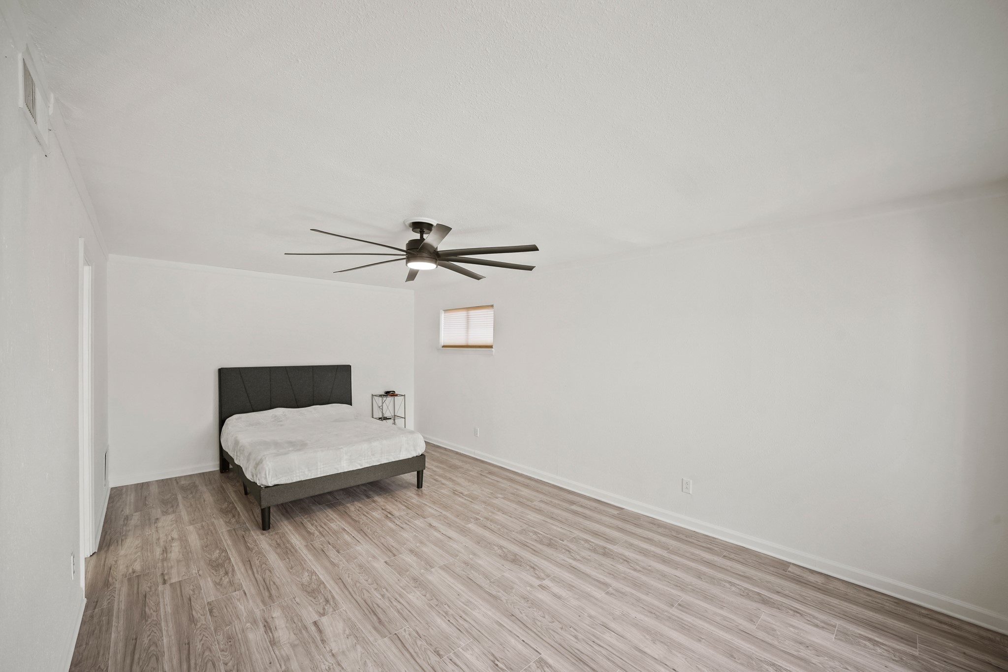 7047 Bissonnet Street, Unit 62 Houston, TX 77074 - Photo 7 of 15 a bedroom with a bed and a chandelier