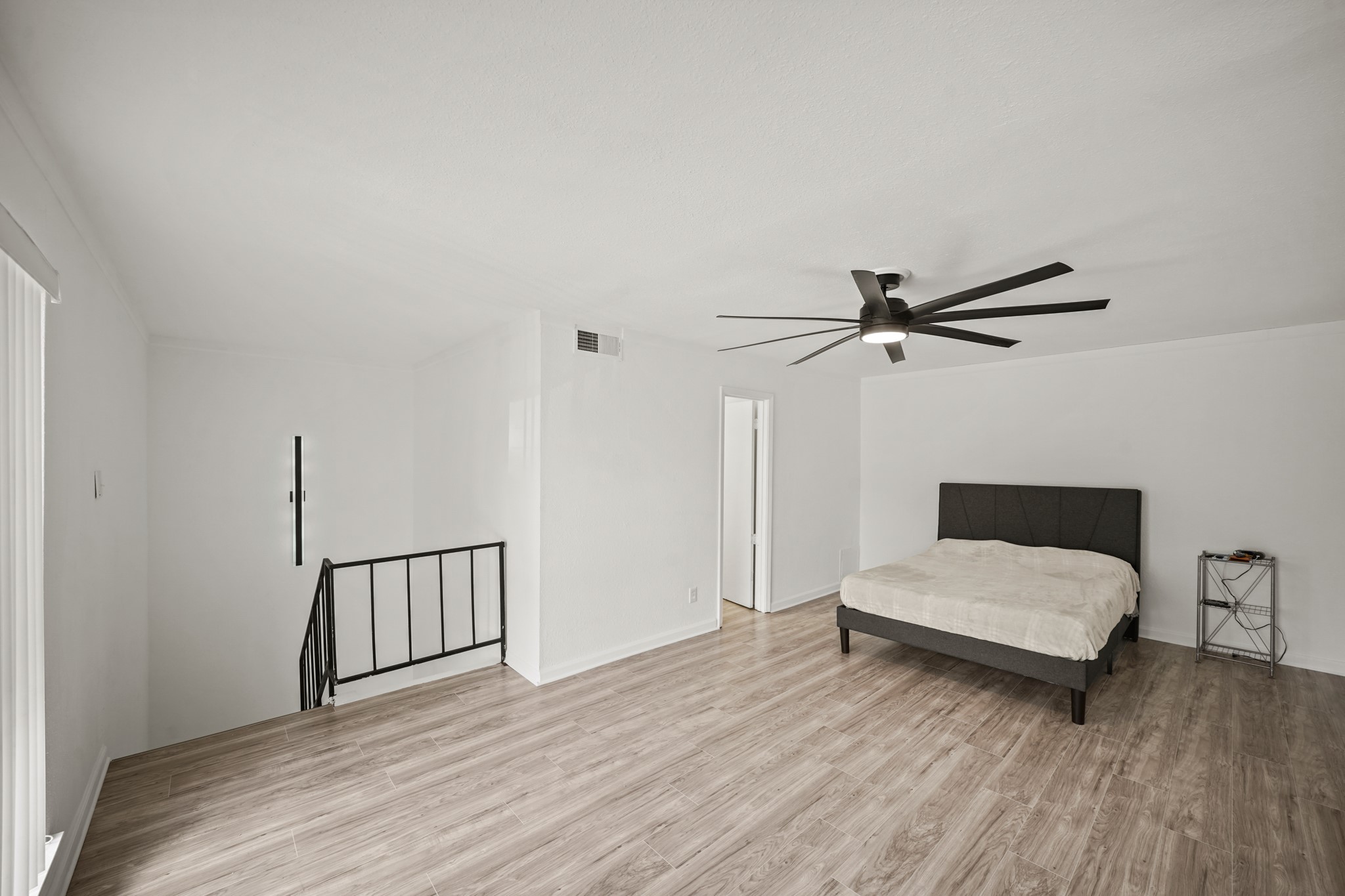 7047 Bissonnet Street, Unit 62 Houston, TX 77074 - Photo 10 of 15 a bedroom with a bed and a chandelier