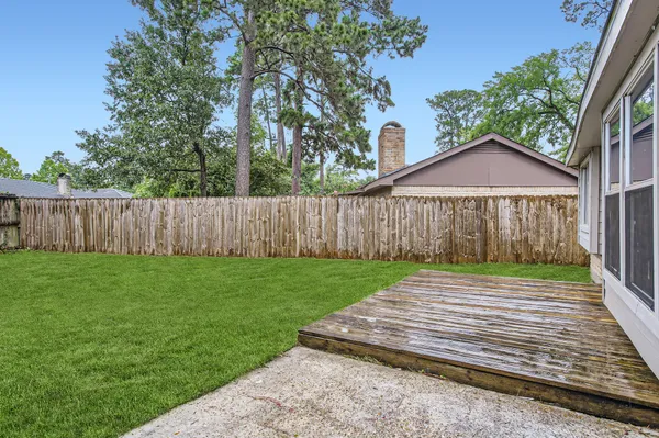 a view of a backyard with wooden fence