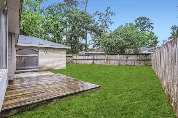 a view of a backyard with wooden fence