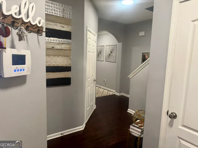 a living room with furniture flowerpot and wooden floor