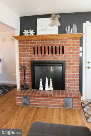 a living room with fireplace furniture and a flat screen tv