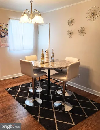 a view of a dining room with furniture and chandelier