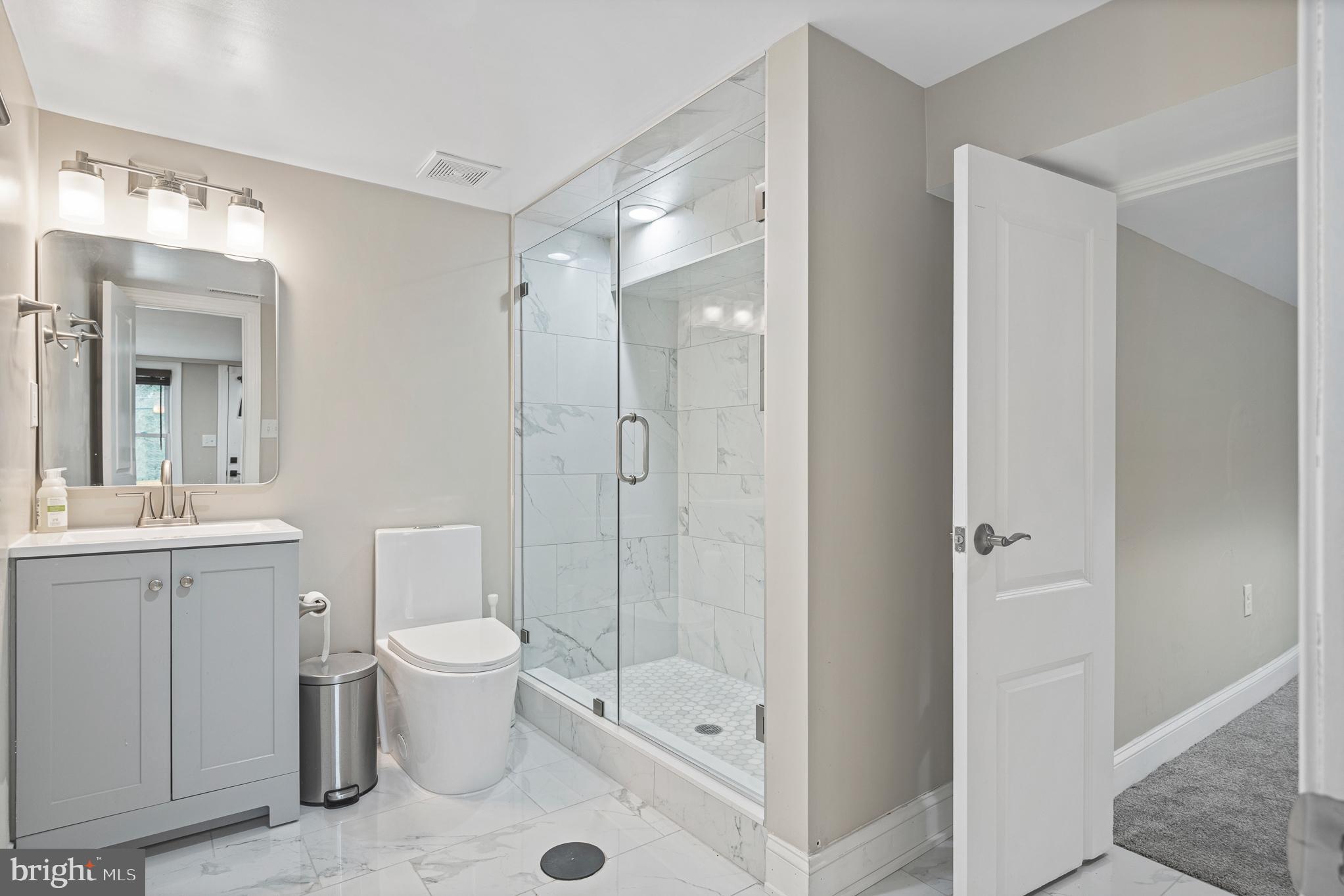 9217 Fowler Lane Lanham, MD 20706 - Photo 60 of 80 a bathroom with a toilet a sink and shower
