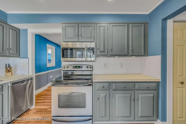 a kitchen with cabinets and appliances