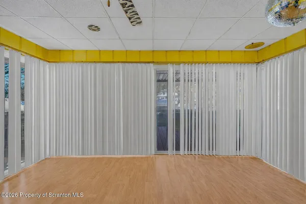a view of a big room with a bed and a chair
