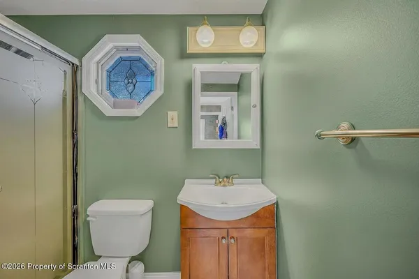 a bathroom with a toilet and a sink