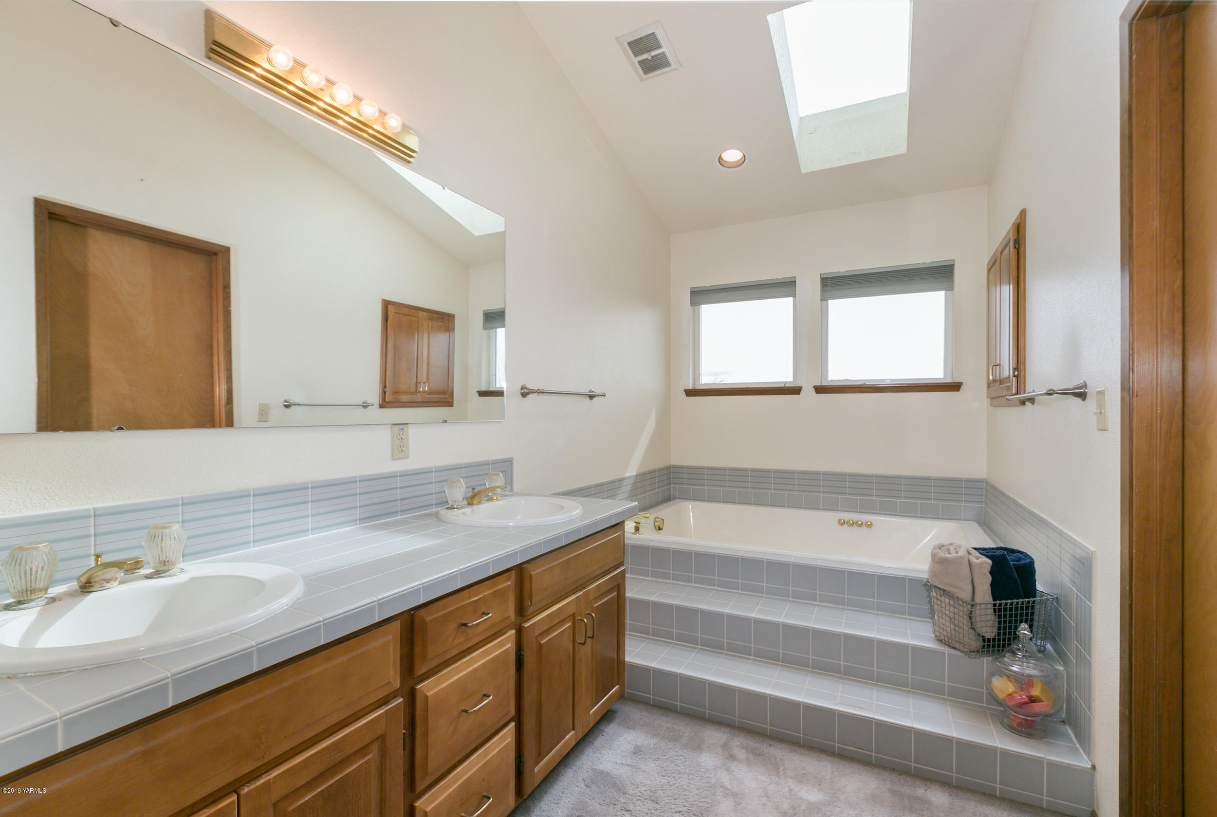 61 Faucher Road Yakima, WA 98901 - Photo 16 of 27 a bathroom with a granite countertop sink and a mirror