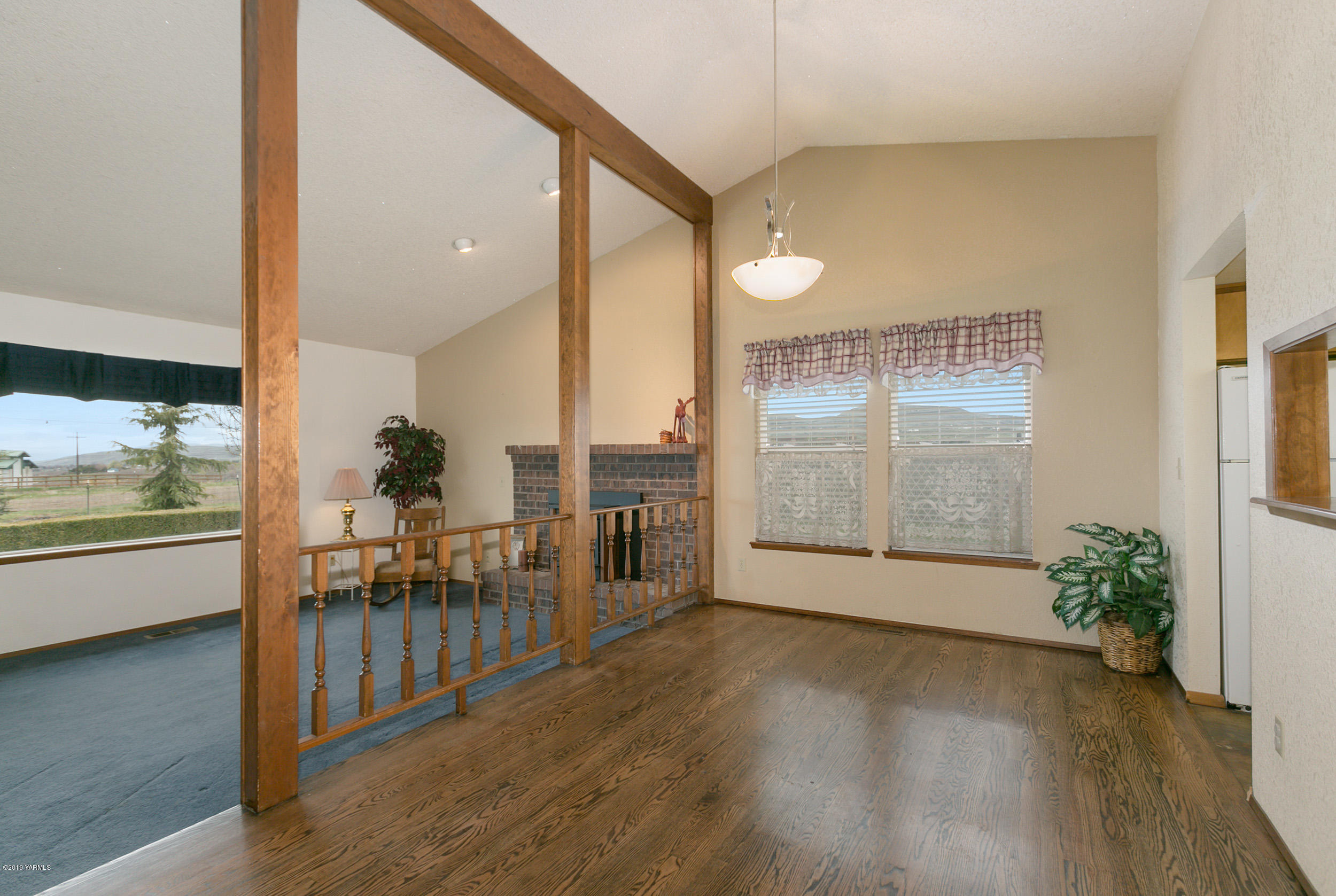 61 Faucher Road Yakima, WA 98901 - Photo 7 of 27 an empty room with wooden floor and windows