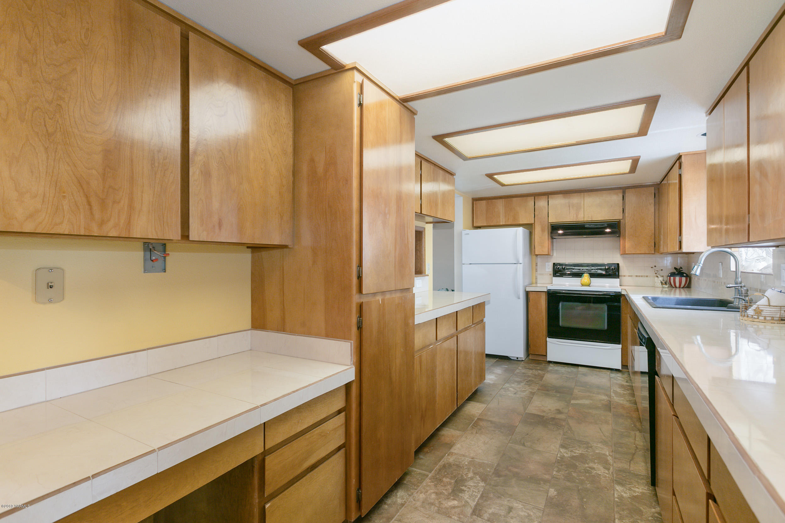 61 Faucher Road Yakima, WA 98901 - Photo 10 of 27 a kitchen with a sink and a refrigerator