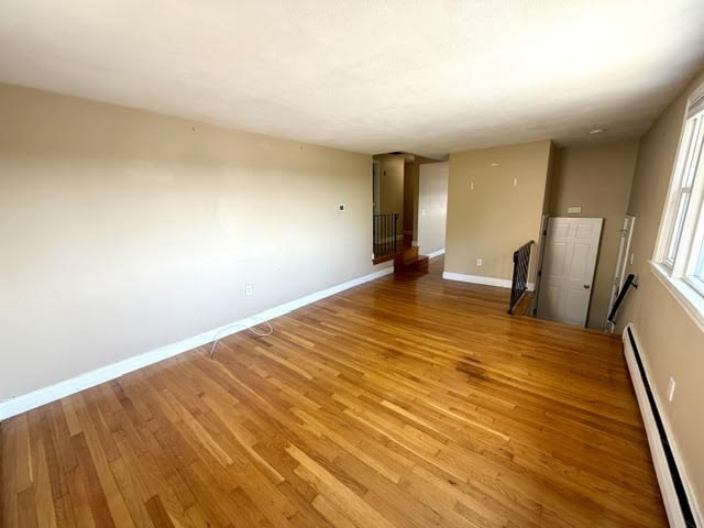 116 Upton Road Waltham, MA 02452 - Photo 9 of 22 a view of empty room with wooden floor