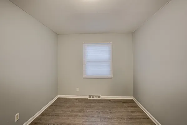 a view of an empty room and wooden floor
