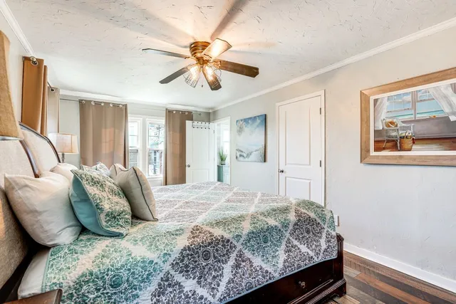 a bedroom with a large bed and a chandelier