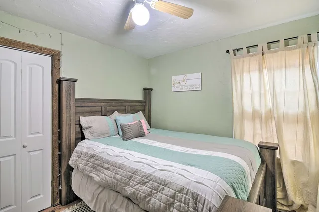 a bedroom with a bed and a window