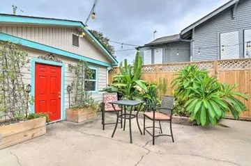 a patio with a table and chairs and potted plants