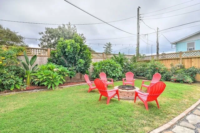 a chair and table sitting in garden with wooden fence