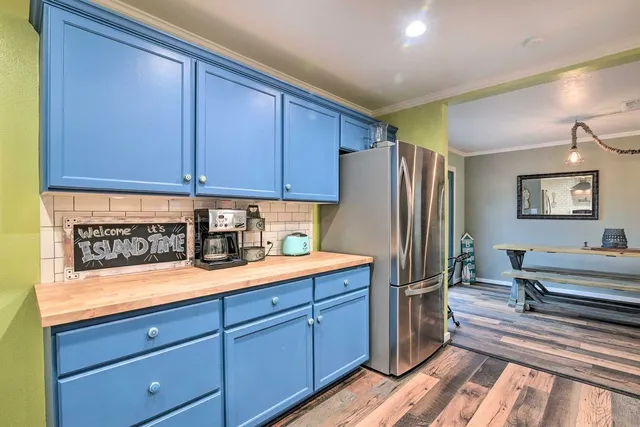 a kitchen with stainless steel appliances granite countertop a refrigerator and a stove top oven