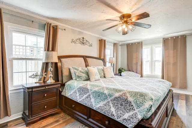 a bedroom with a bed and a chandelier