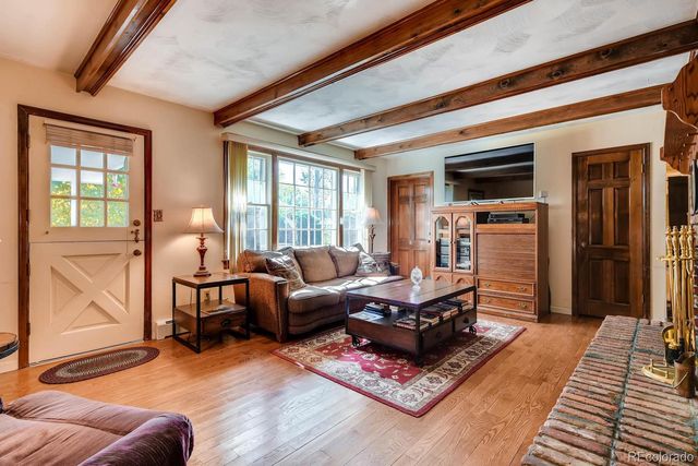 a living room with furniture rug and wooden floor