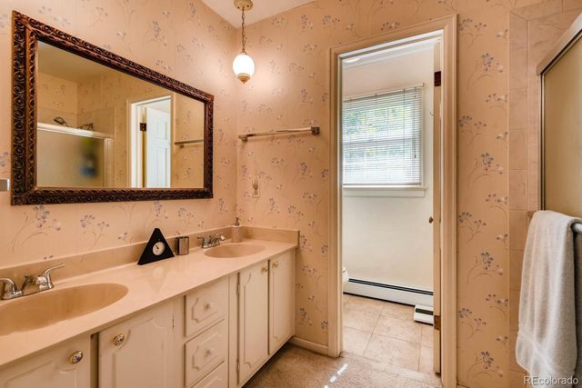 a bathroom with a double vanity sink and mirror