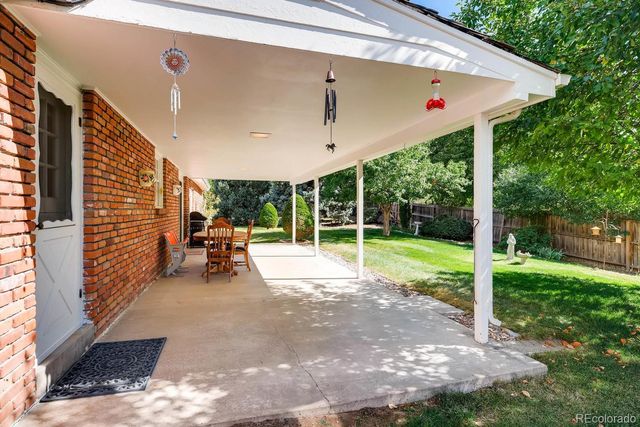 a view of a backyard with porch and garden