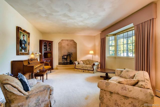 a living room with furniture and large windows