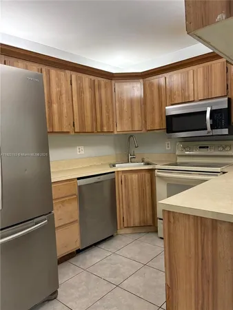 a bedroom with a bed and a refrigerator