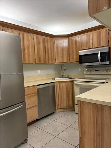 a bedroom with a bed and a refrigerator