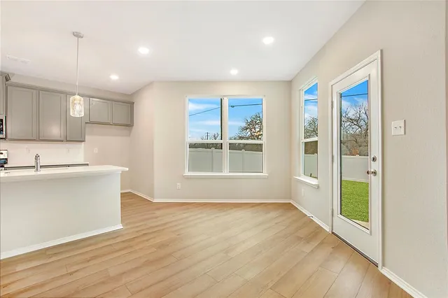 a view of kitchen with wooden floor and electronic appliances