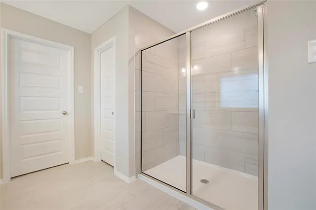 a bathroom with a glass shower door