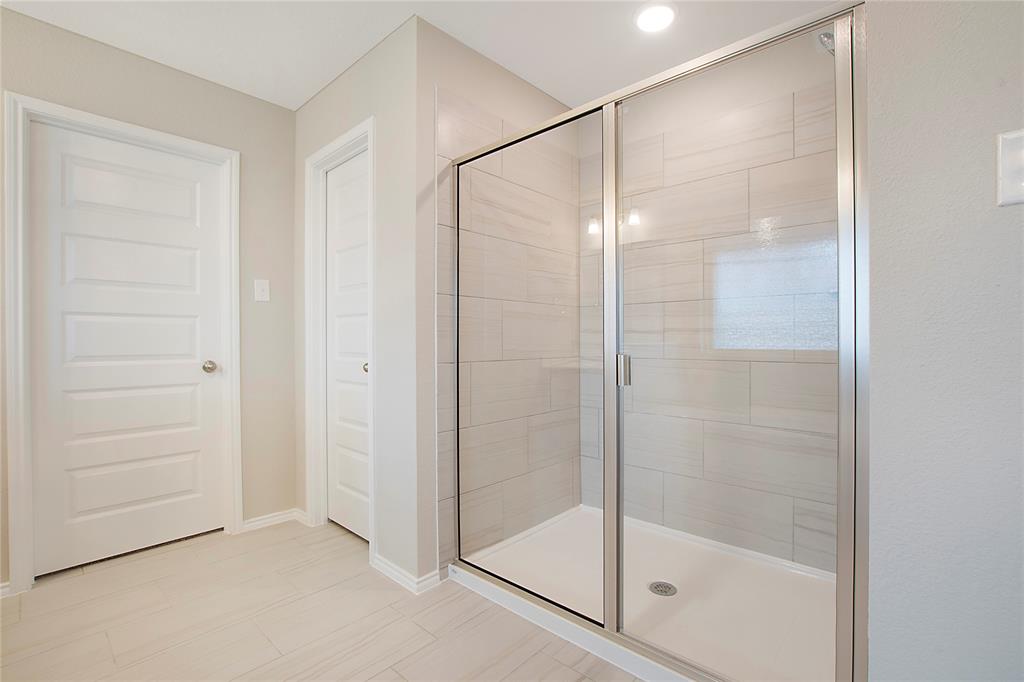1605 Katharina Avenue Providence Village, TX 76227 - Photo 26 of 35 a bathroom with a glass shower door