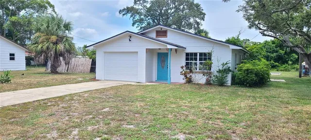 a view of a house with a yard and garage