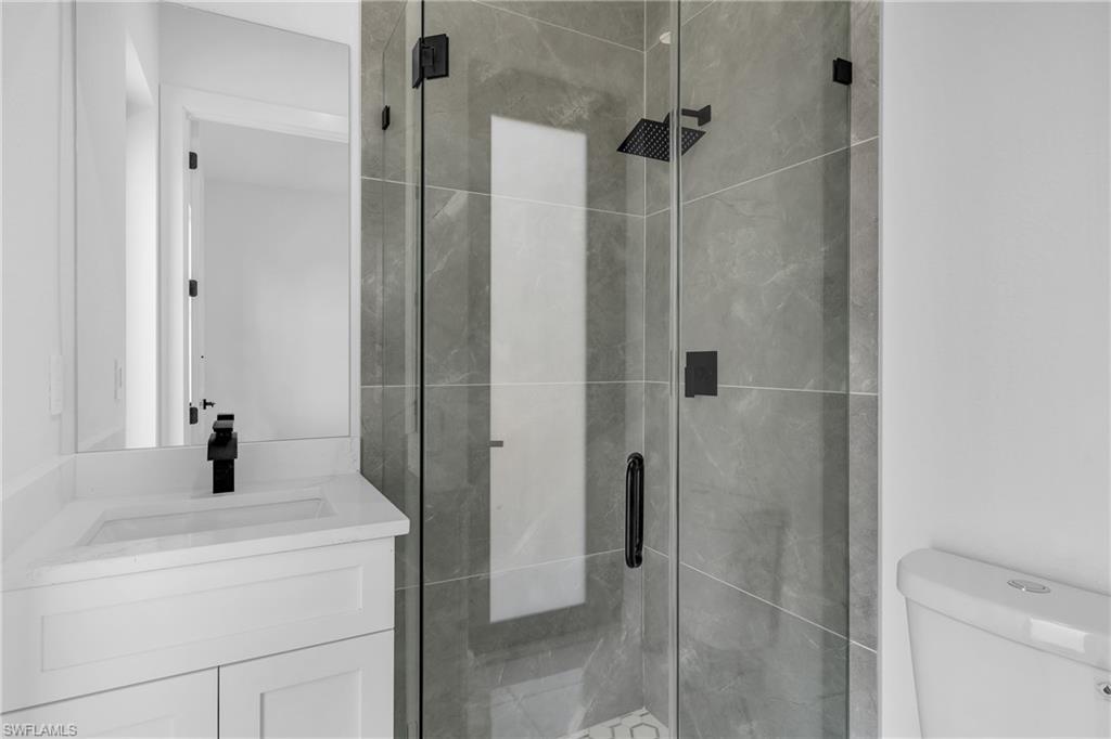 3110 23rd Street Southwest Lehigh Acres, FL 33976 - Photo 11 of 16 Bathroom featuring a shower stall and vanity
